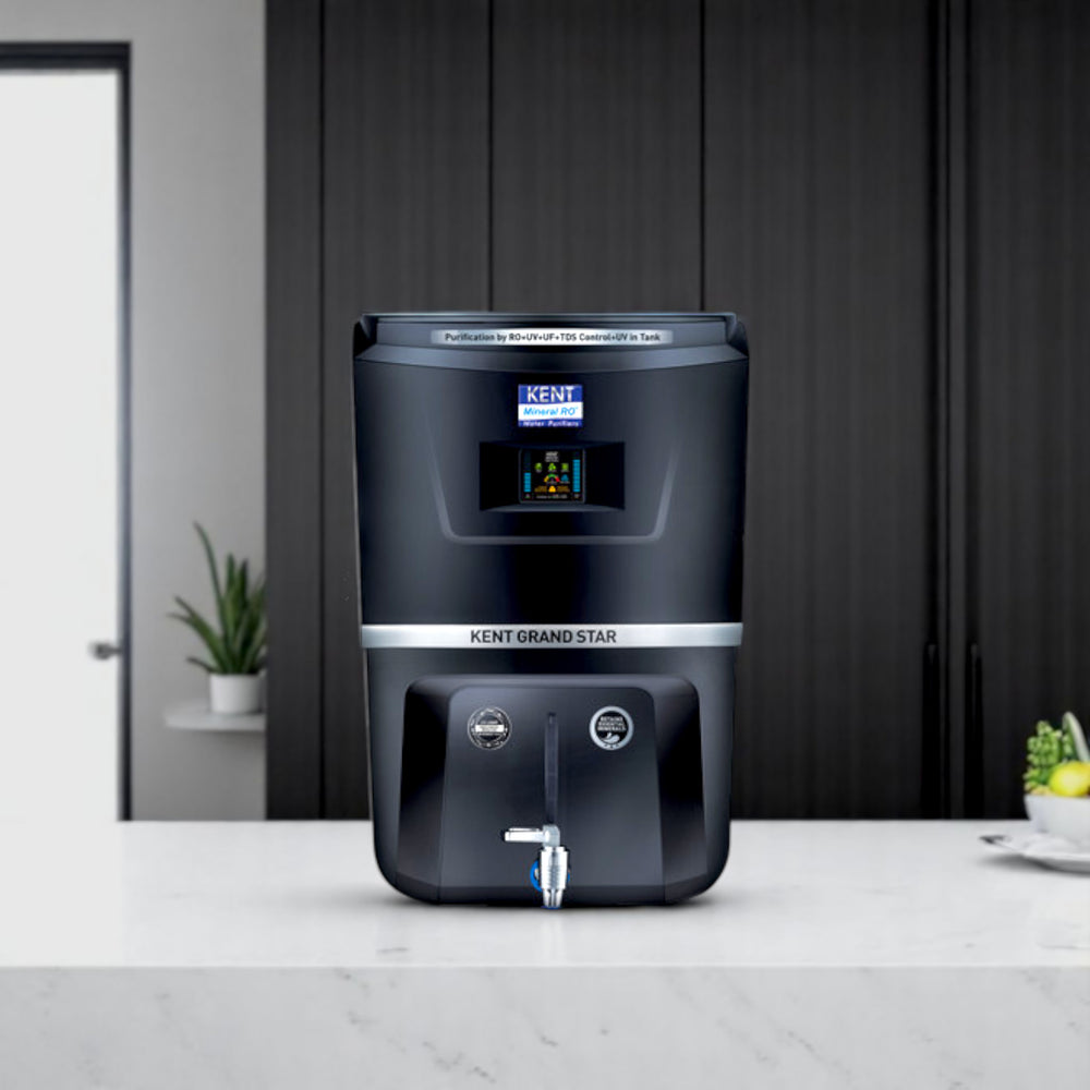 Kent Grand Star water purifier in black showing the digital screen display, a metallic tap dispenser, and RO plus UV plus UF purification status.