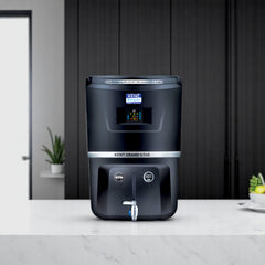 Kent Grand Star water purifier in black showing the digital screen display, a metallic tap dispenser, and RO plus UV plus UF purification status.