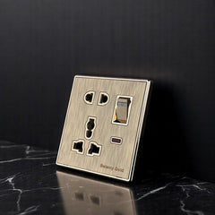 Belamy Gold multi 5-pin socket with rocker switch, LED indicator and brushed gold finish, model BE-141-SW.