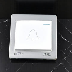 Belamy white-grey push bell switch with bell icon, blue indicator and silver-grey frame, model BE-123-SW.