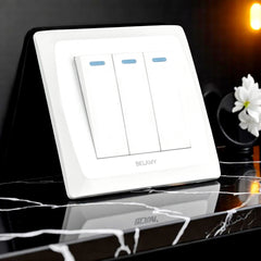 Belamy white 3 gang 1 way switch with three rocker controls and blue indicator strips, model BE-131-SW.