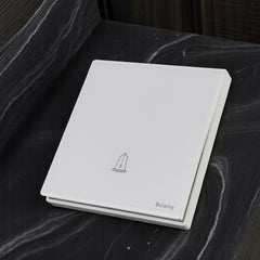 Belamy white push bell switch with bell icon and minimalist white wall plate design, model BE-155-SW.
