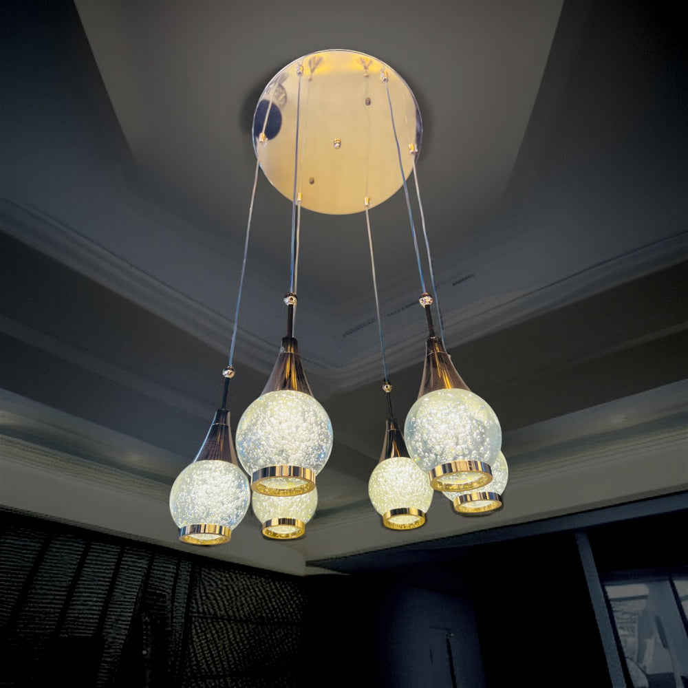 Qulik Aurora Drops hanging light with 6 crystal-style pendant globes, gold accents and 3-color illumination.