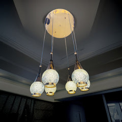 Qulik Aurora Drops hanging light with 6 crystal-style pendant globes, gold accents and 3-color illumination.