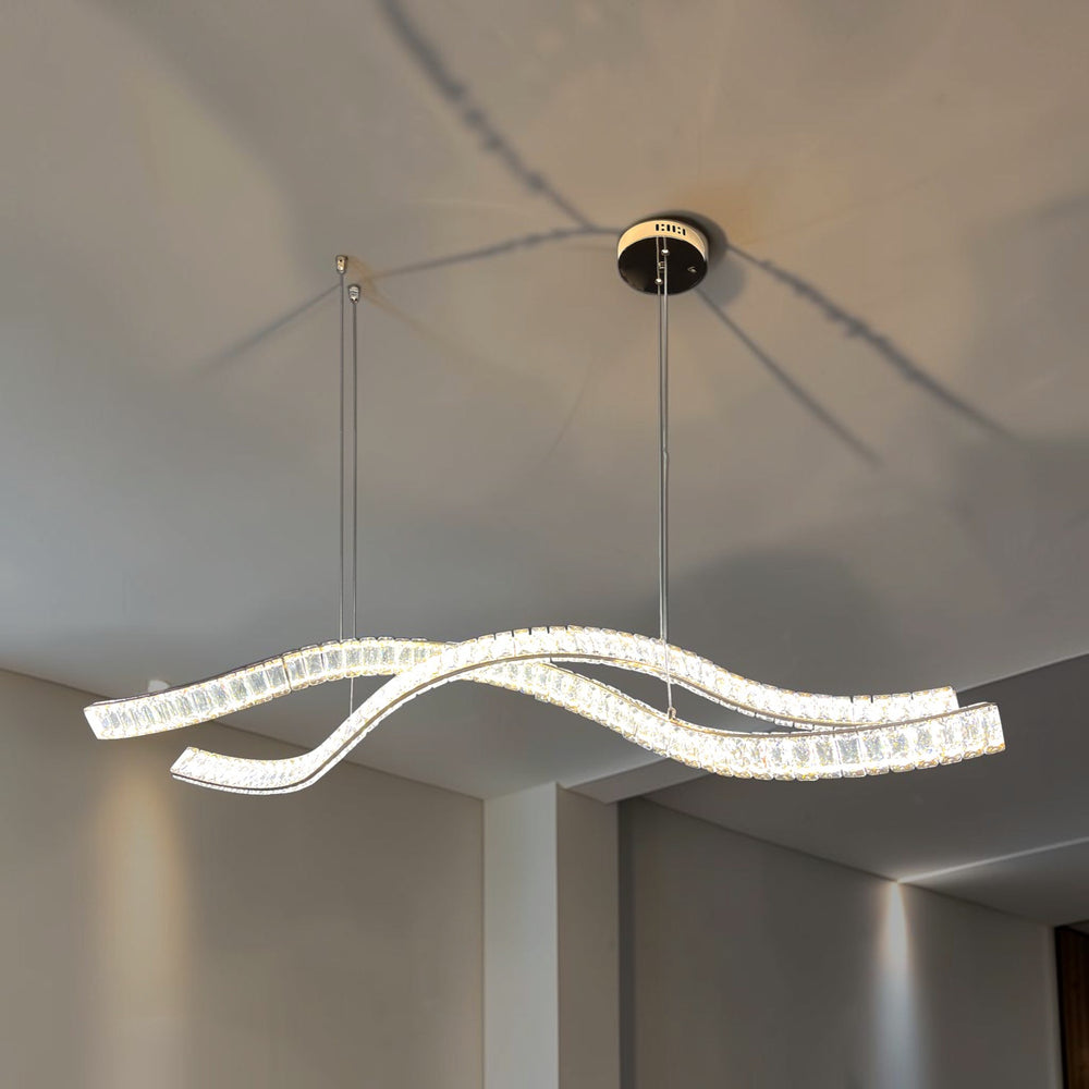 Qulik double wave crystal LED chandelier with French Gold finish, clear textured crystal strips and suspended curved design.